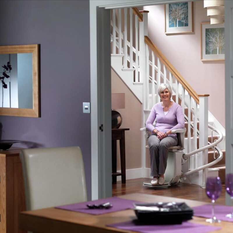 woman sitting on stairlift