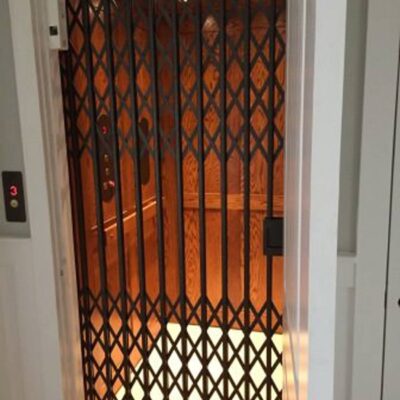 Area-Access-Symmetry-Home-Elevator-with-Vintabe-Bronze-collapsible-gate-e1589928970678