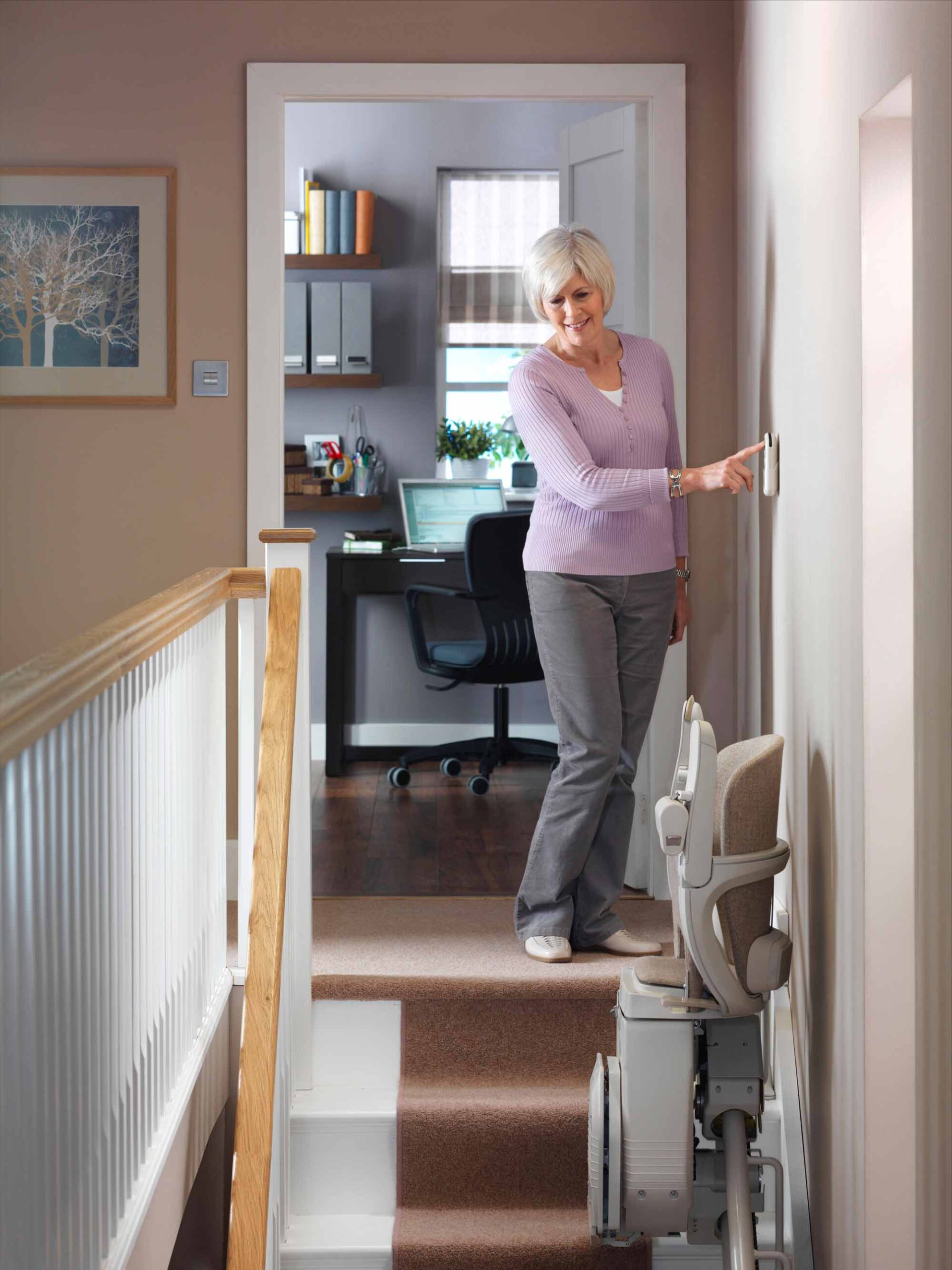 woman calling up stairlift