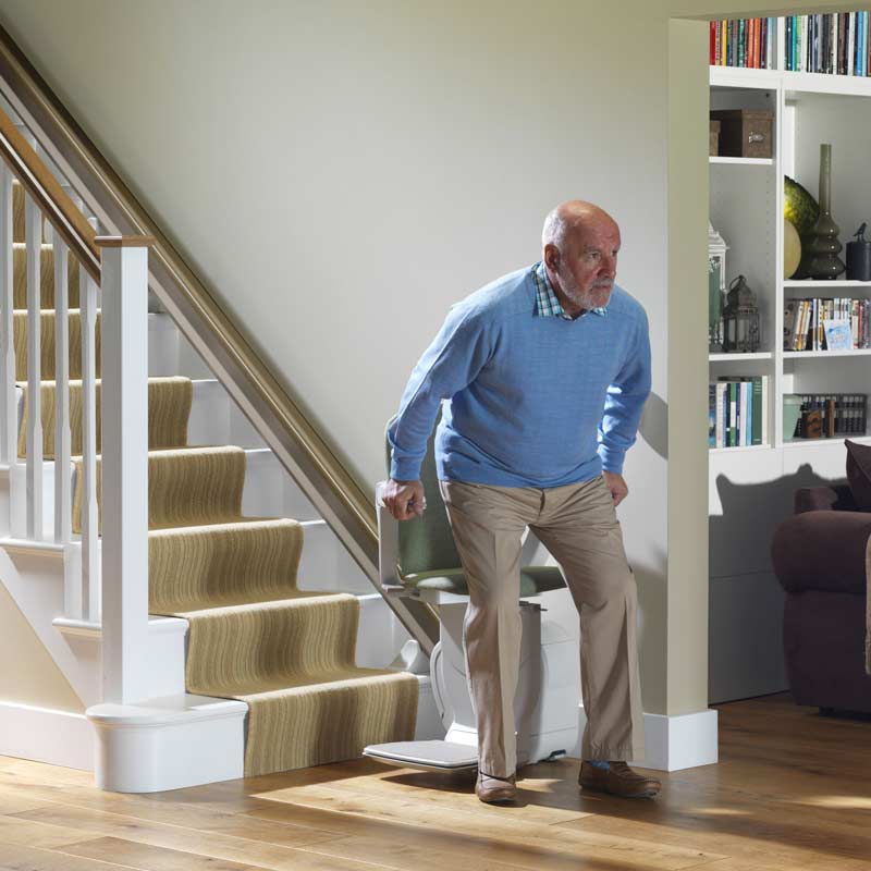 man getting off stairlift
