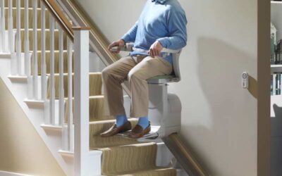 man riding up stairlift at home